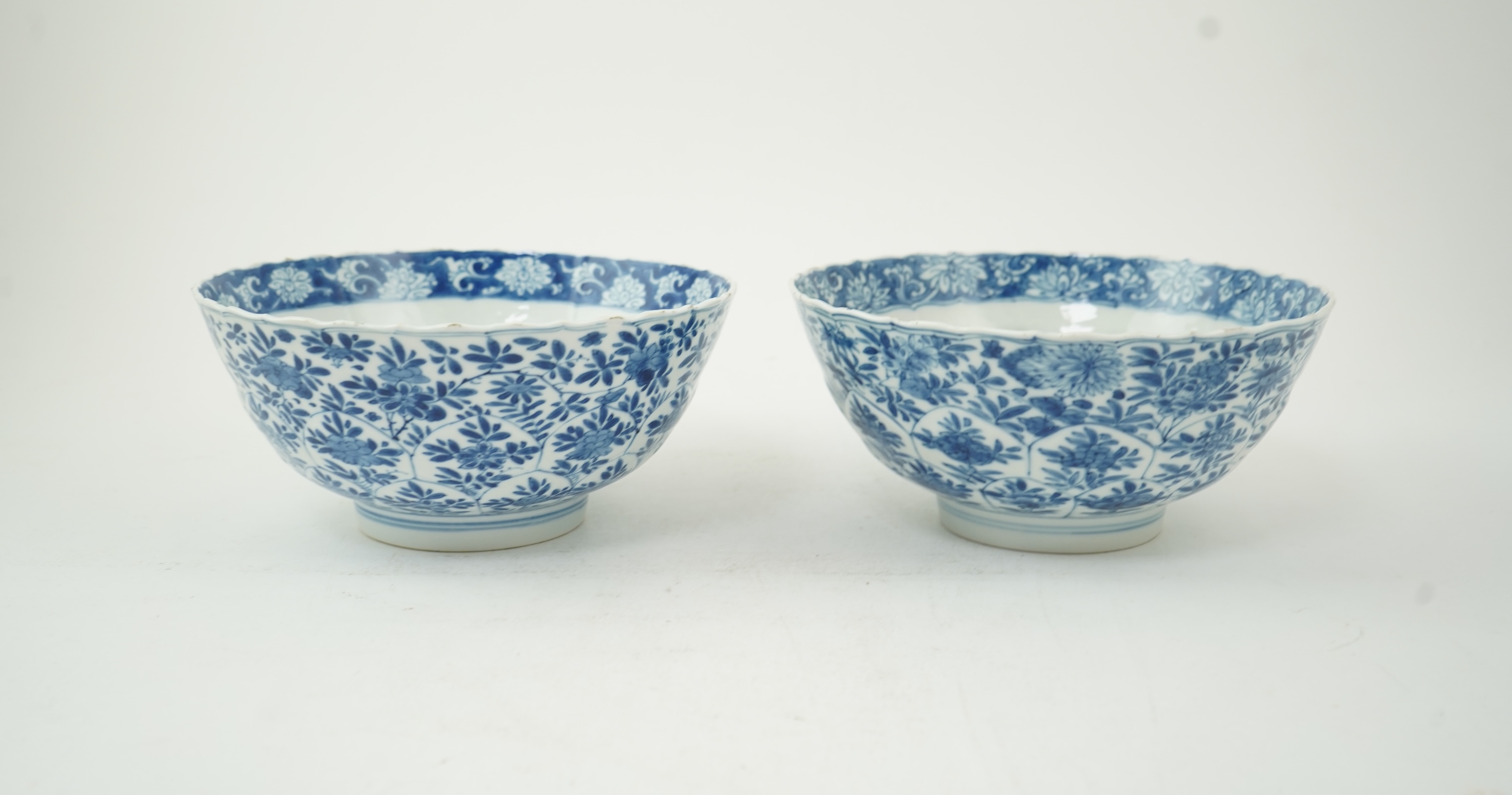 A near pair of Chinese blue and white lotus flower moulded bowls, Kangxi period